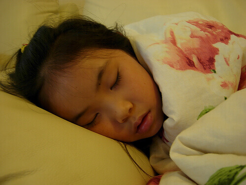 Girl sleeping due to fever
