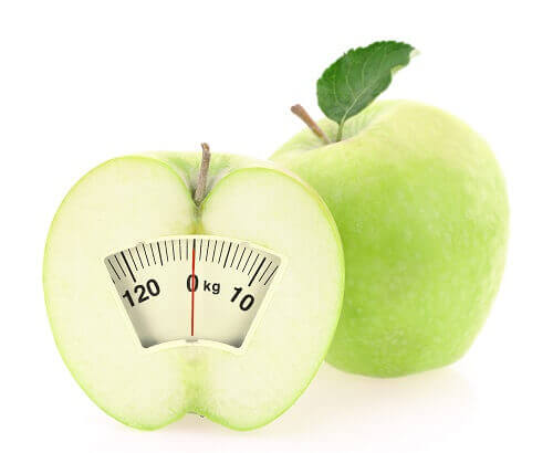 Ett äpple med en skala som visar att gå ner i vikt