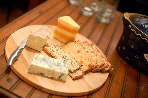 A cheese board with biscuits.