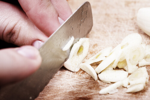 Man cutting garlic