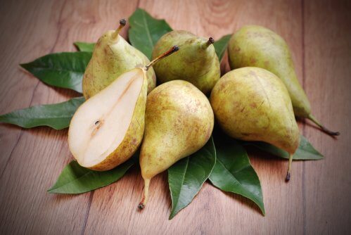 Fresh pears among leaves