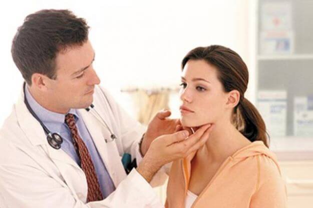 Doctor checking woman's lymph nodes