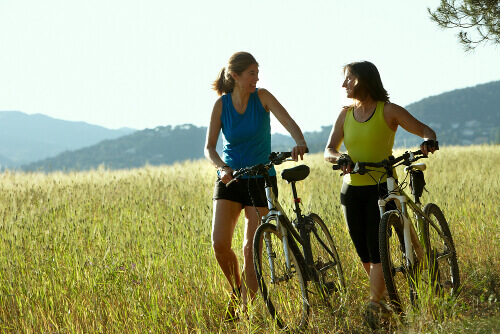 Two women exercising outside bikes awake all night