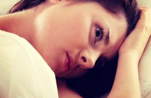 Woman awake all night in bed with insomnia