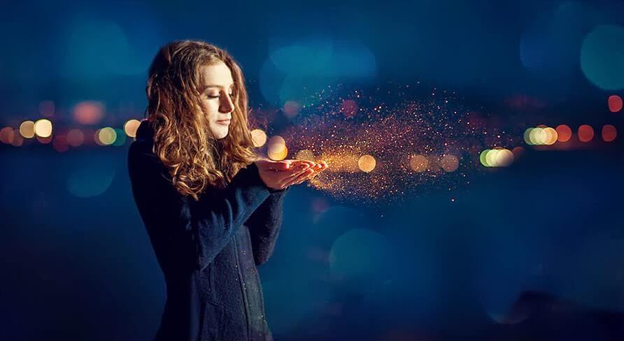 Woman blowing dust into the wind