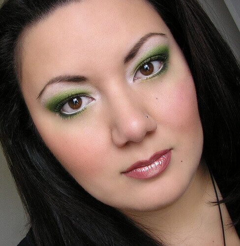 Woman with green eye makeup awake all night