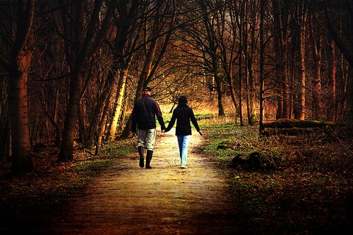 Couple walking on a forest trail
