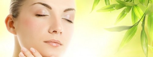 Woman with perfect skin eyes closed glowing skin