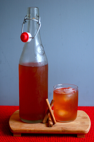 Jar of cinnamon drink and glass