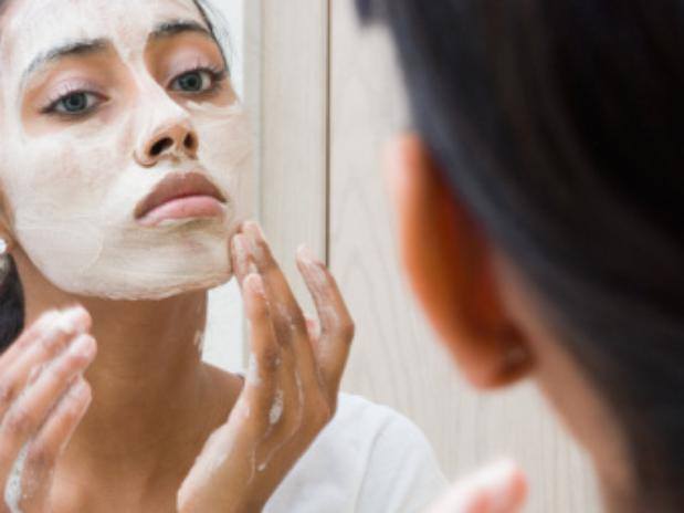Woman applying a face mask