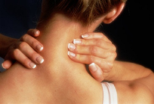 woman rubbing her neck
