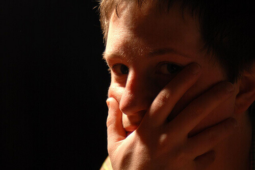 Person with hand over their mouth