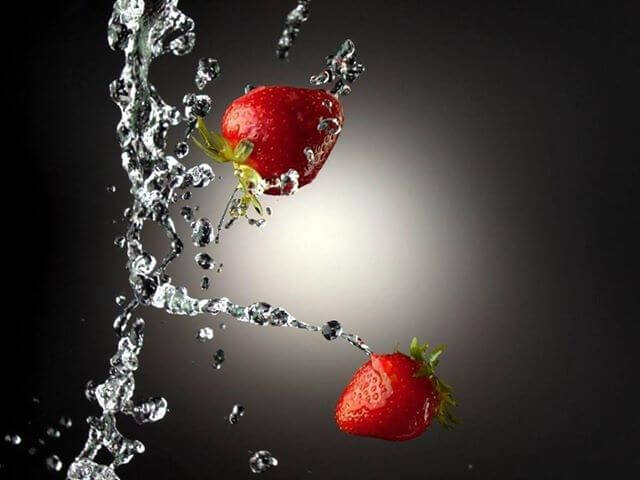 Srawberries falling down with a stream of water