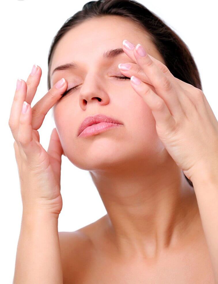 Woman massaging her eyes as a way to rejuvenate your skin