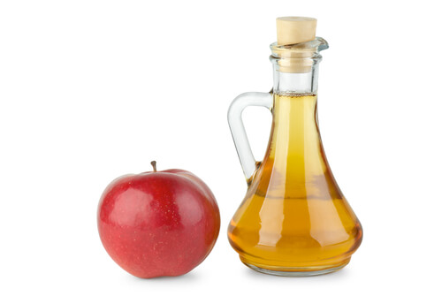 Vinegar bottle and apple