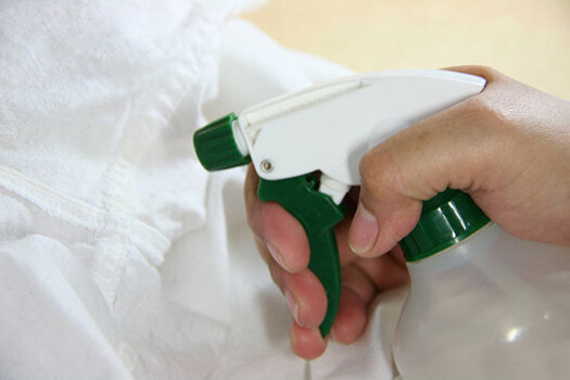 A person whitening clothing.