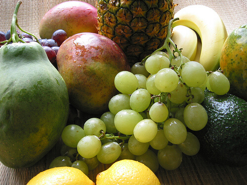 red and green grapes, mango, pineapple, lemons, avocados, and bananas