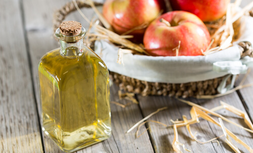 A glass bottle with apple cider vinegar