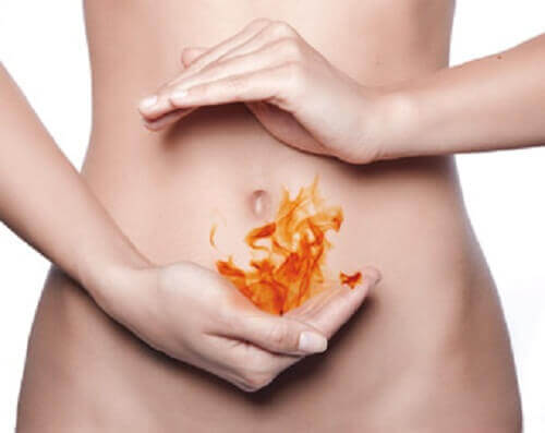 Fire image on a bare abdomen representing heartburn causes of stomach aches