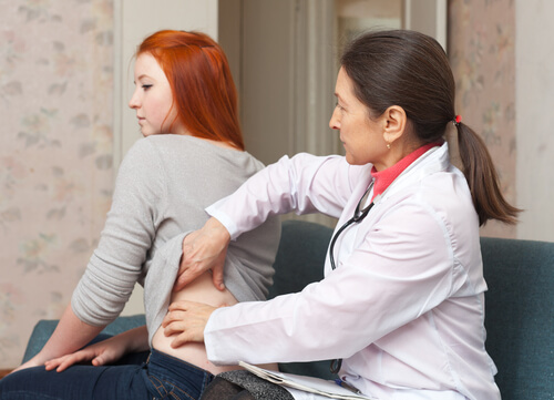 doctor checking woman's kidneys