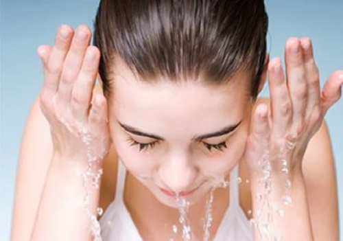 Woman washing her face