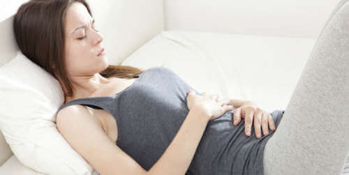 Woman with stomach pain because she has gallstones
