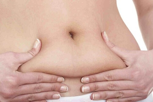 Woman pinching her belly