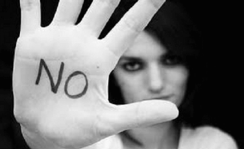 Woman making a stop sign with her hand to illustrate setting limits for toxic family members