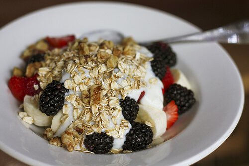 Having cereals and fruit for breakfast