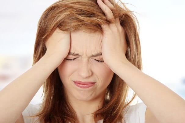 woman with migraine from drinking cow's milk too much