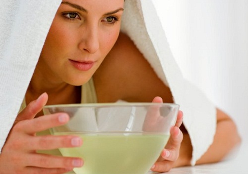 Woman with bowl with towel over her head