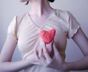 A woman holding her heart.