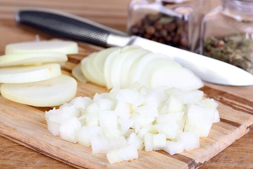 Some diced onion on a cutting board.