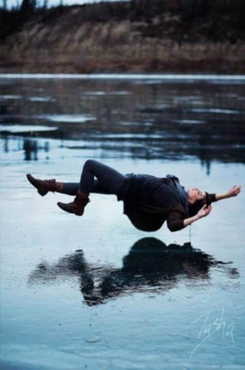 A girl having a falling dream above water