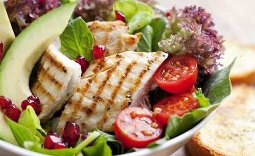 Bowl of salad with a grilled chicken breast