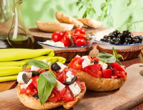 Two whole grain breads topped with tomatoes