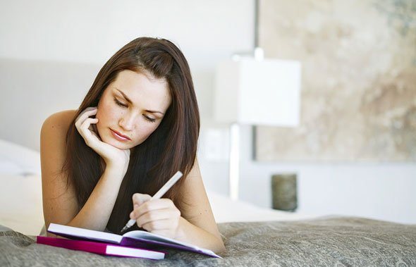 a woman writing, making time for herself to grow personally