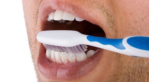 A man using a toothbrush