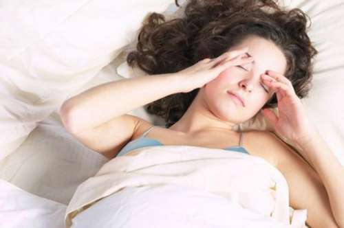 woman laying down on a mattress