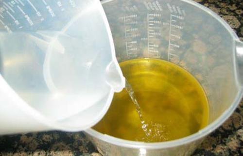 Pouring water into oil