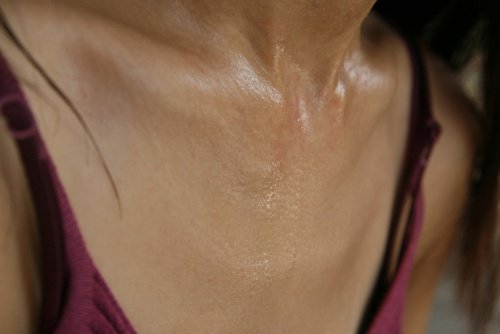 A woman sweating in the chest area