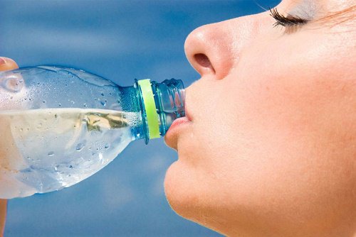 Woman drinking bottled water.