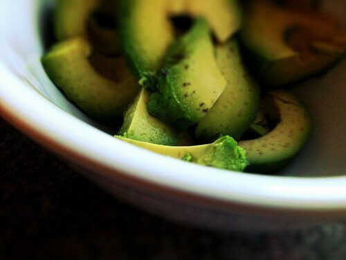 Natural remedies with avocado chopped in bowl