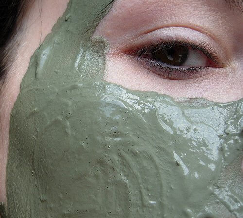 A woman with a clay mask.
