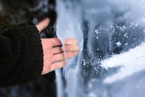 Man putting hand through ice