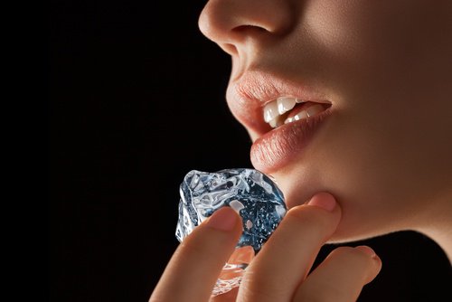 Woman with ice cube on chin