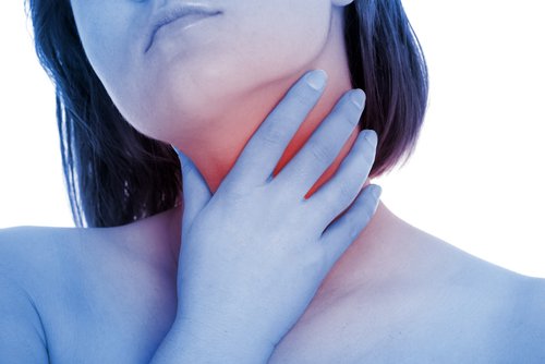 Woman suffering from swollen tonsils