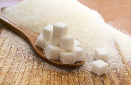 A spoon with some sugar cubes.
