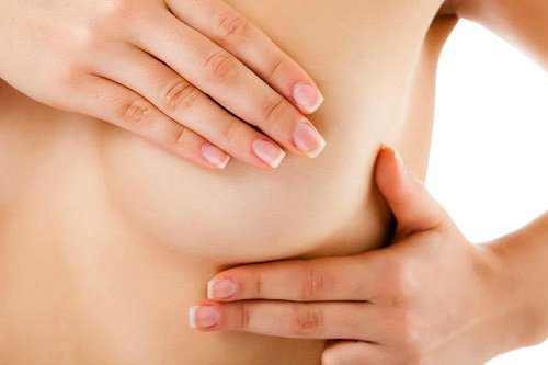 Nude woman covering her nipple