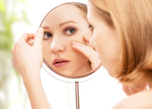 Woman looking at herself in a mirror